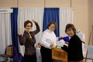 Members of AAM registrar's committee flex their muscle as they setup their booth.